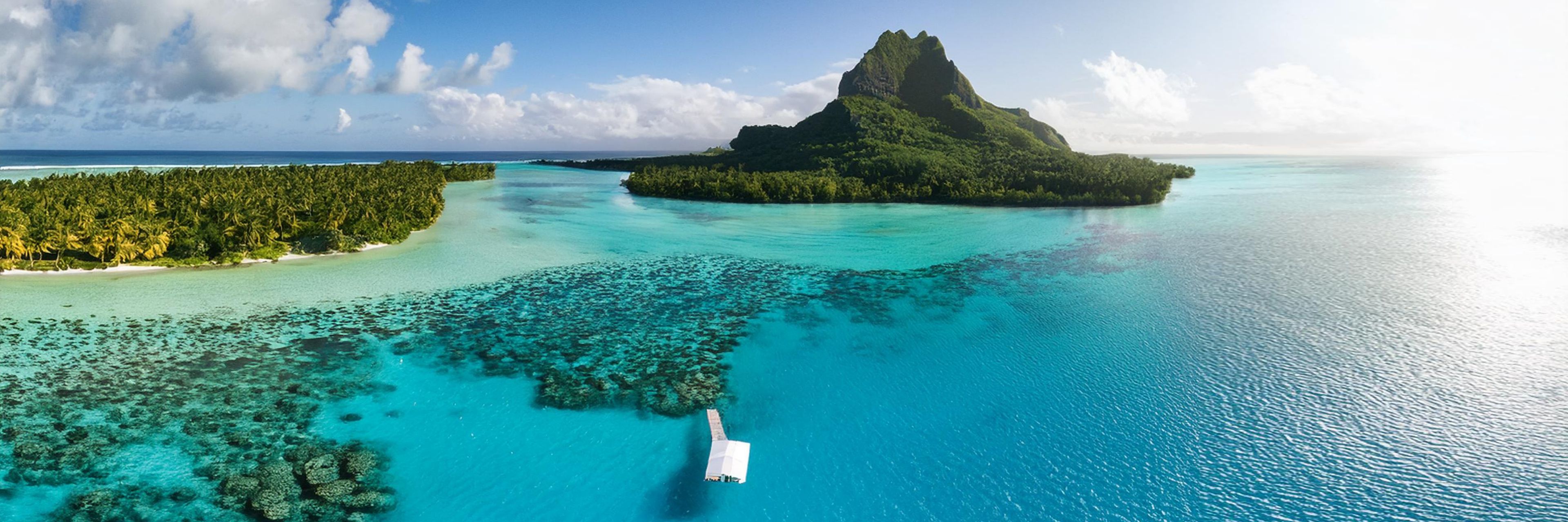 Island surrounded by bright blue water. 