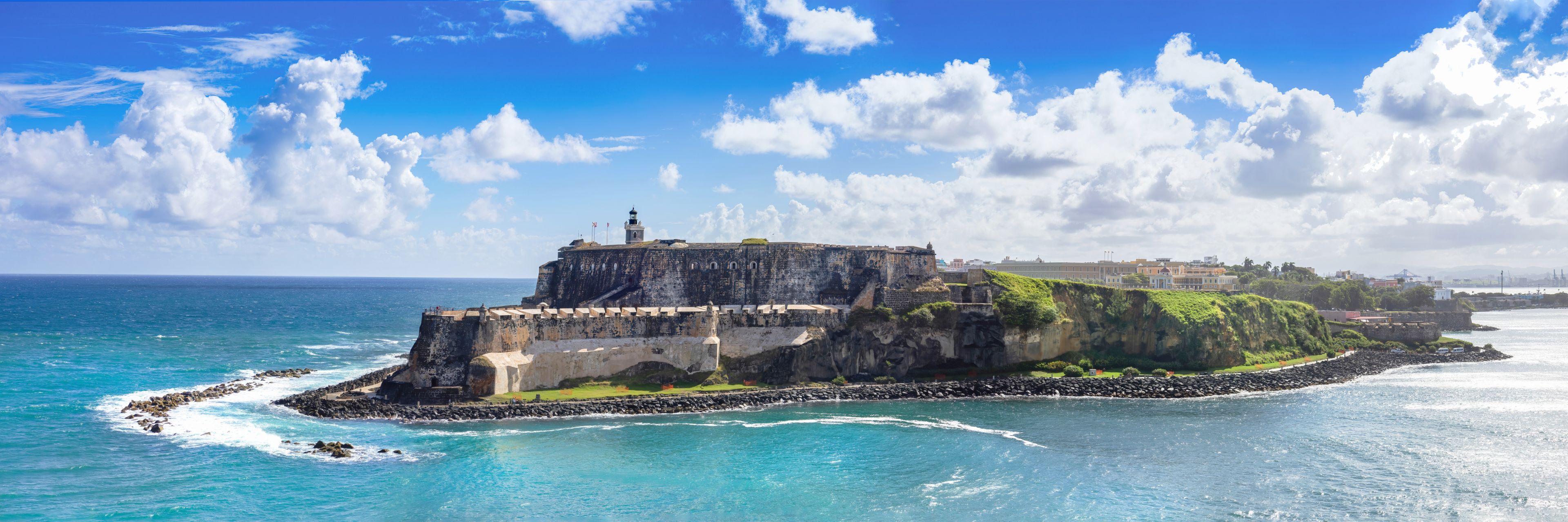 Castle on the edge of the beach overlooking the ocean. 