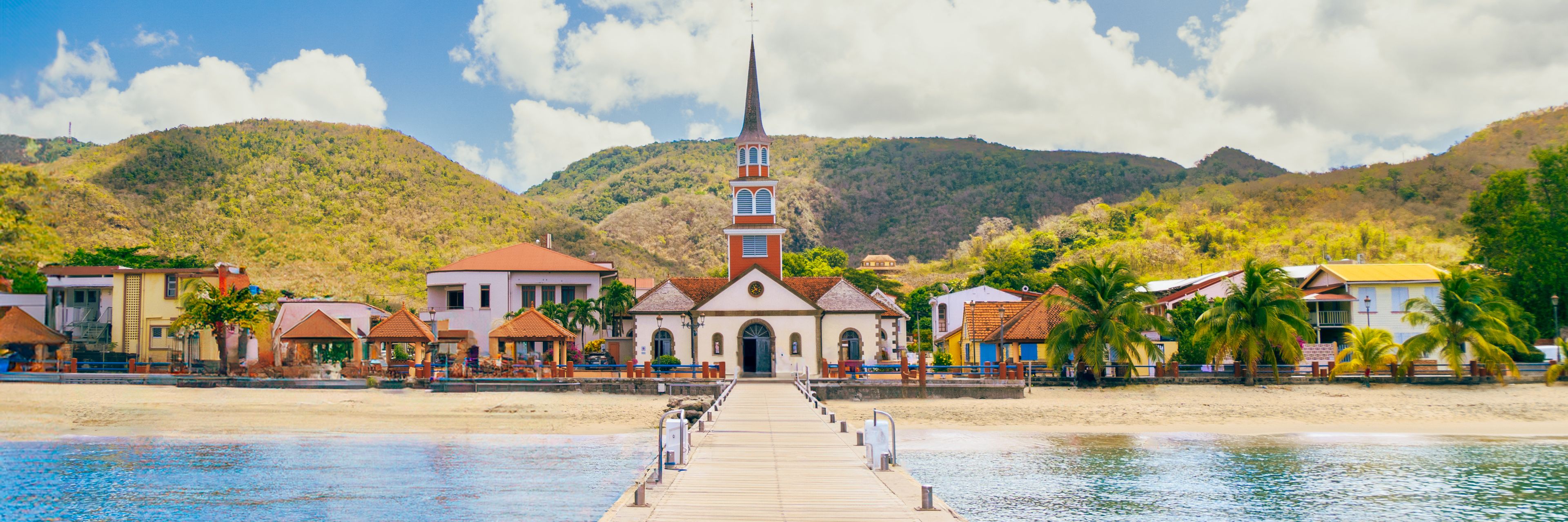 Dock view looking at the island and building that line the shore. 