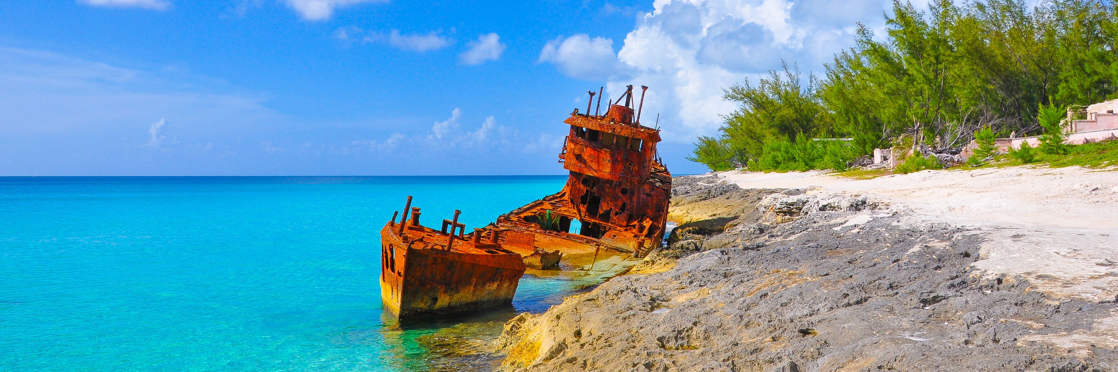 Boat wrecked along shore. 
