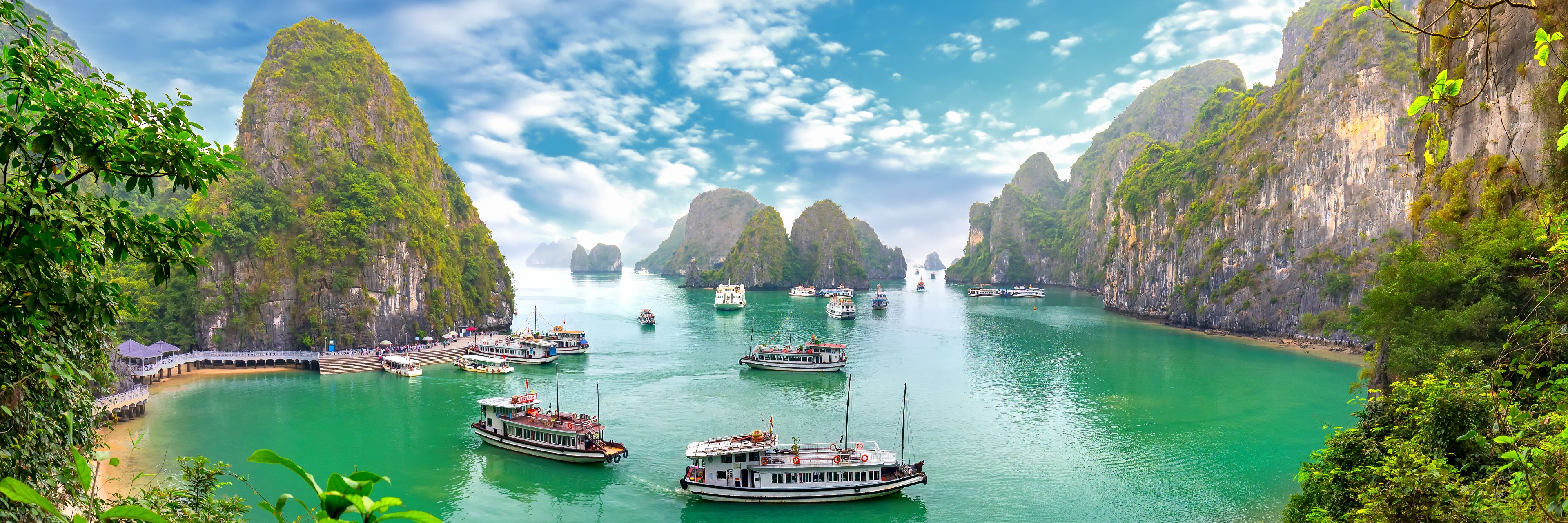 Variety of boats anchored or cruising along the shore. 