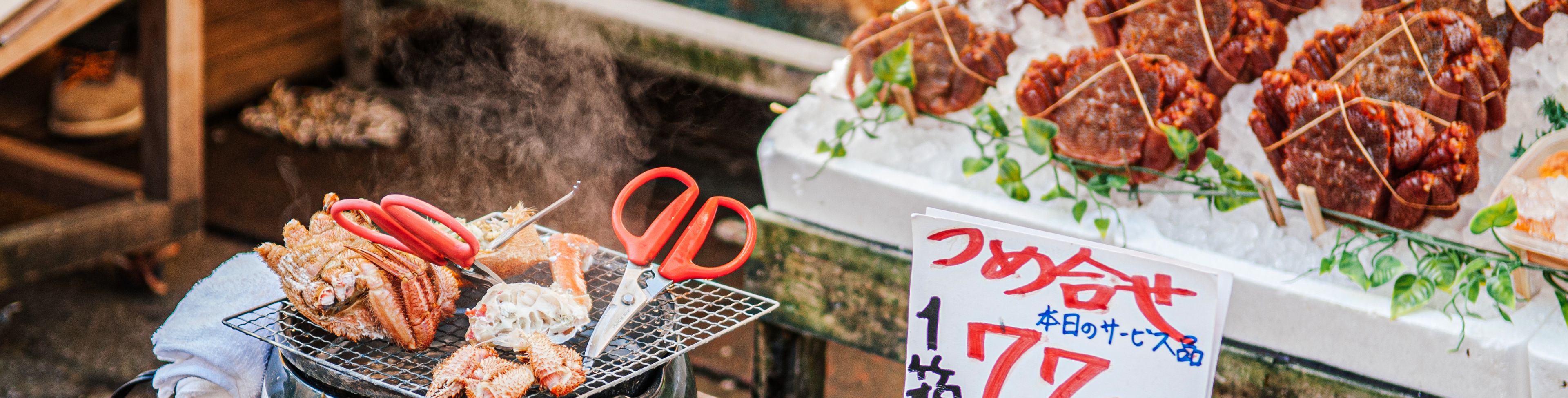 Food being cooked and sold at a market stand. 