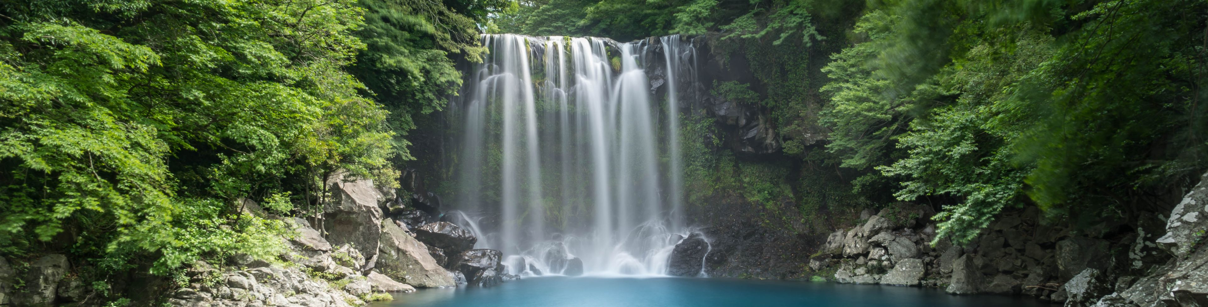 Waterfall into a small area of water. 
