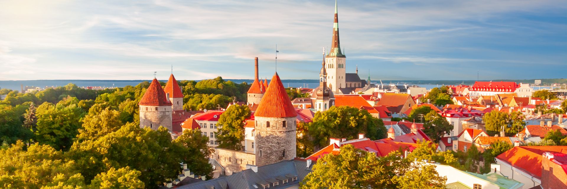 Orange tiled buildings dotted throughout a heavily wooded city.