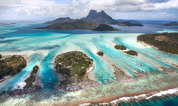 Aerial view of sandy beaches and clear blue waters. 