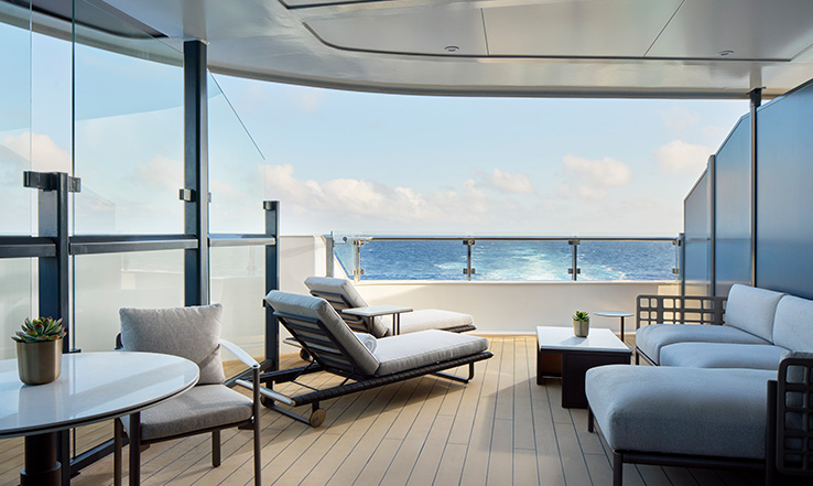 Lounge chairs on a deck. 