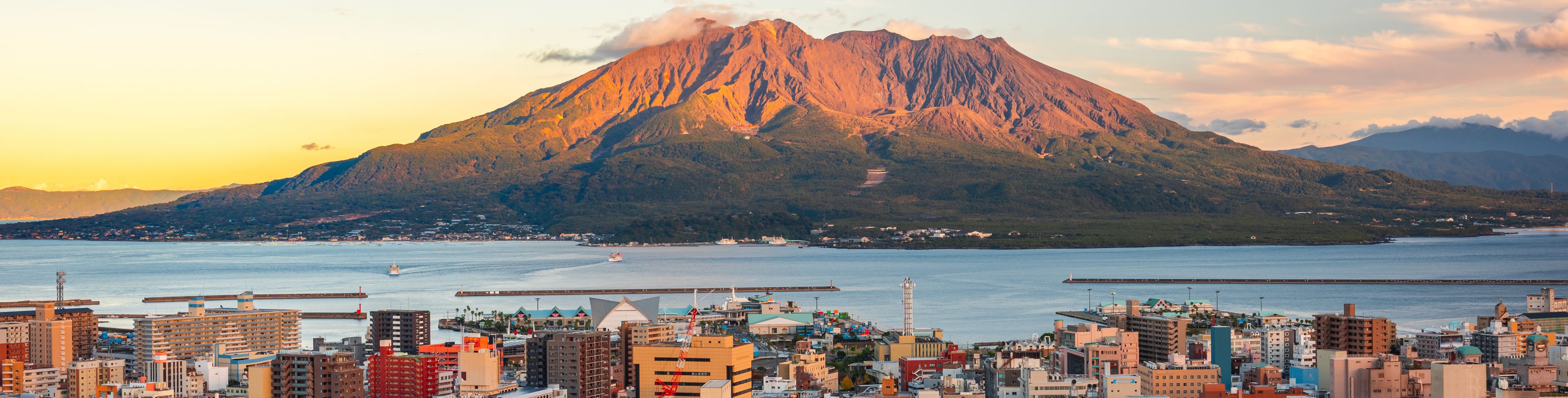 Aerial view of city with mountain in the distance.