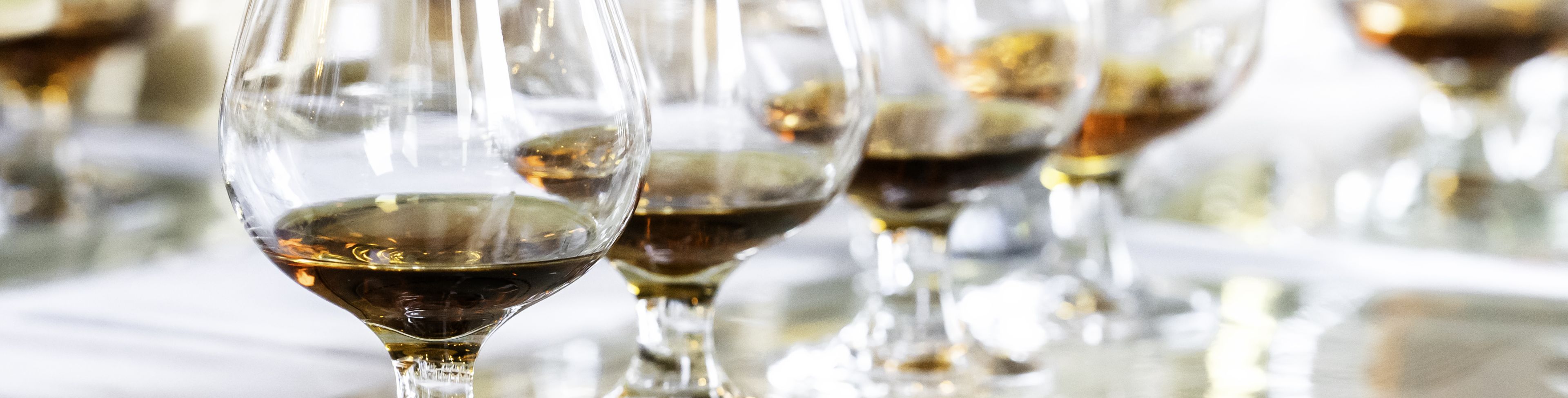 A line of glasses partially filled with Rum. 