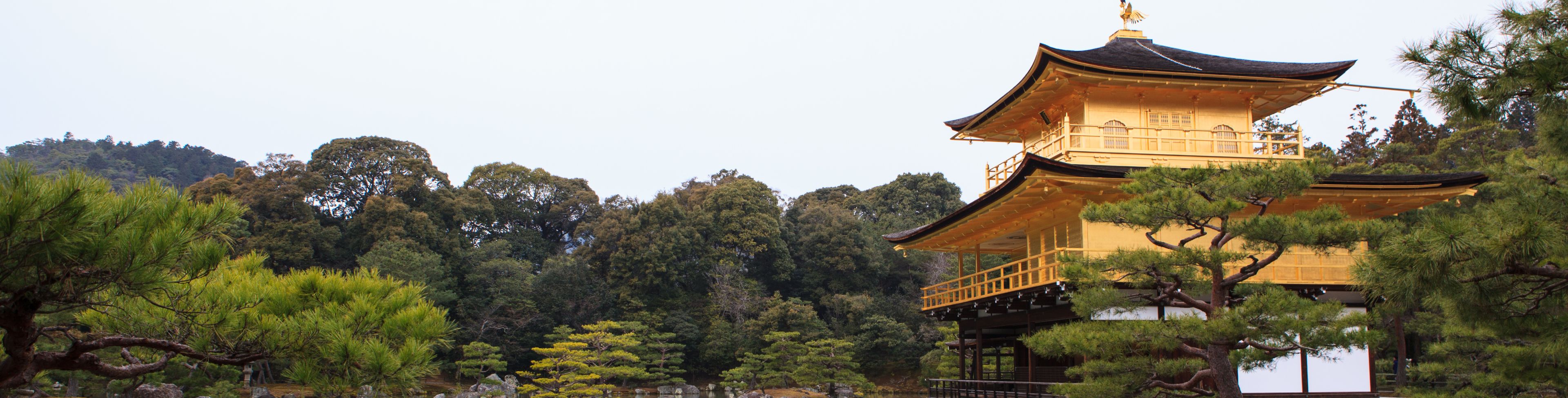 Temple surrounded by nature and a body of water. 