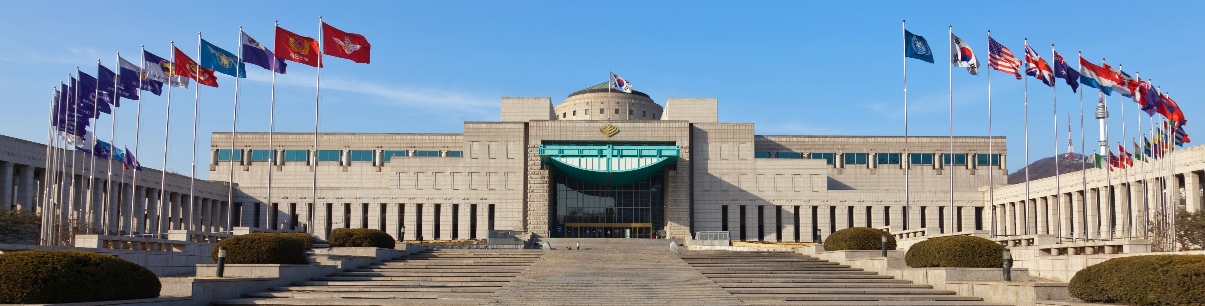 Historic building surrounded by flags. 