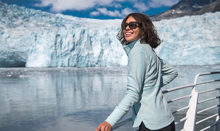 Woman looking out a glacier in the distance.