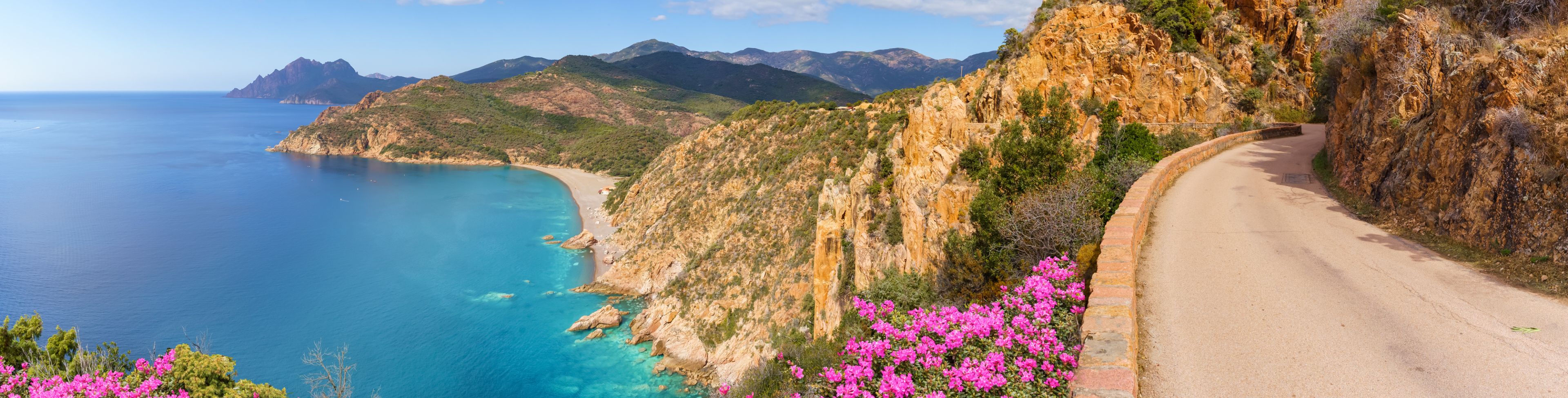 Mountainside view of beach and island.