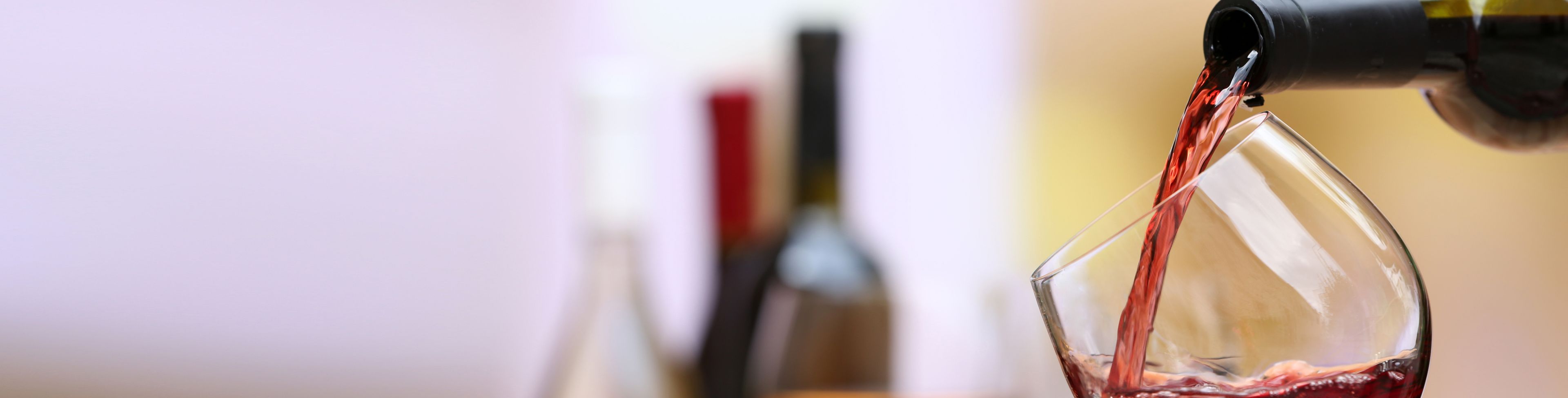 Wine being poured into a glass.