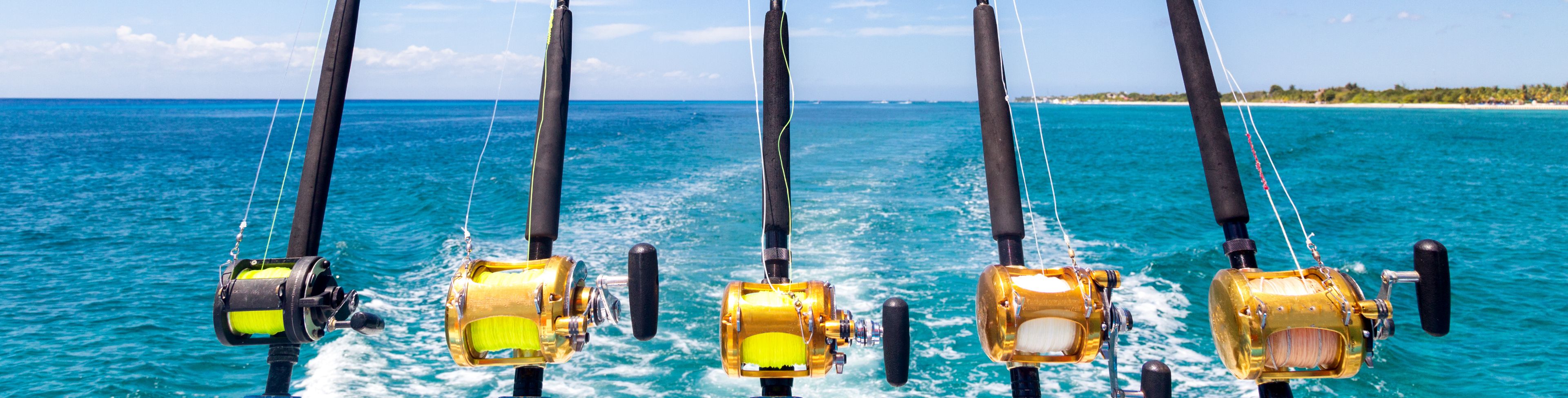 Fishing poles attatched to the back of boat at sea.