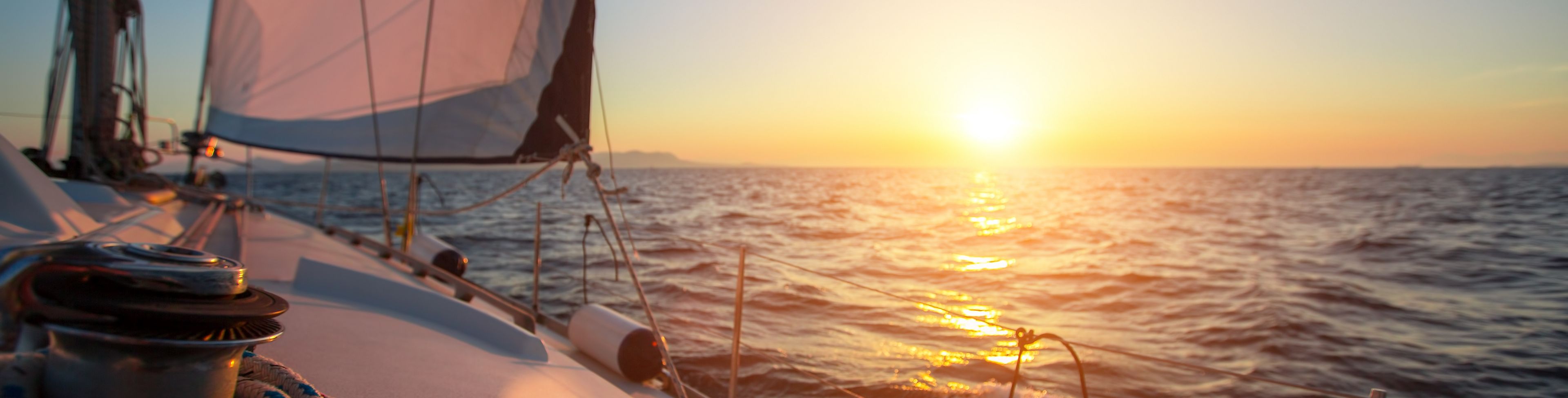 Sailboat on the sea at sunset.