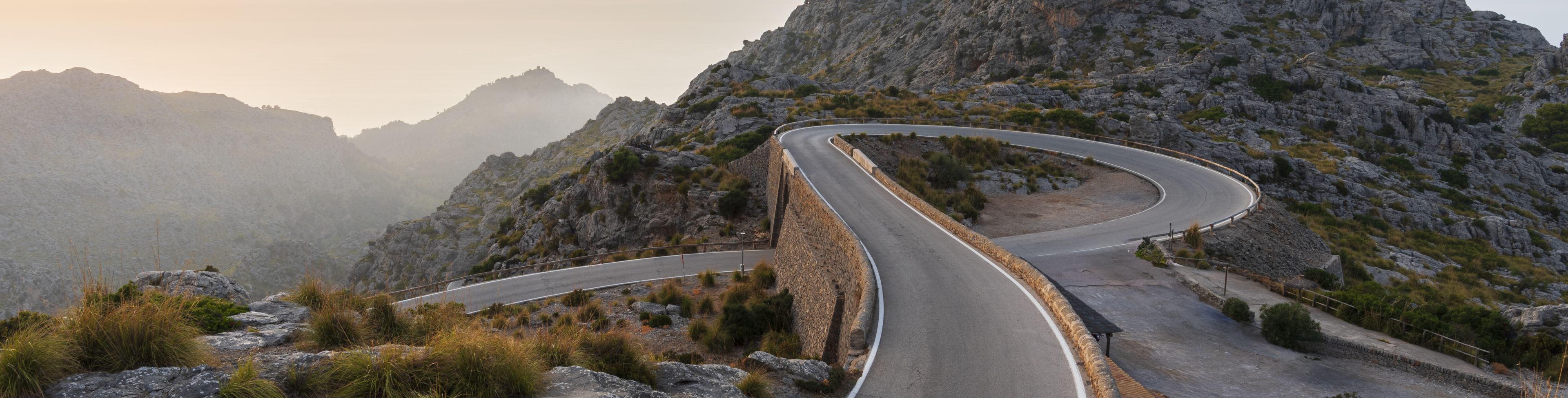 A winding road curves around mountain peaks