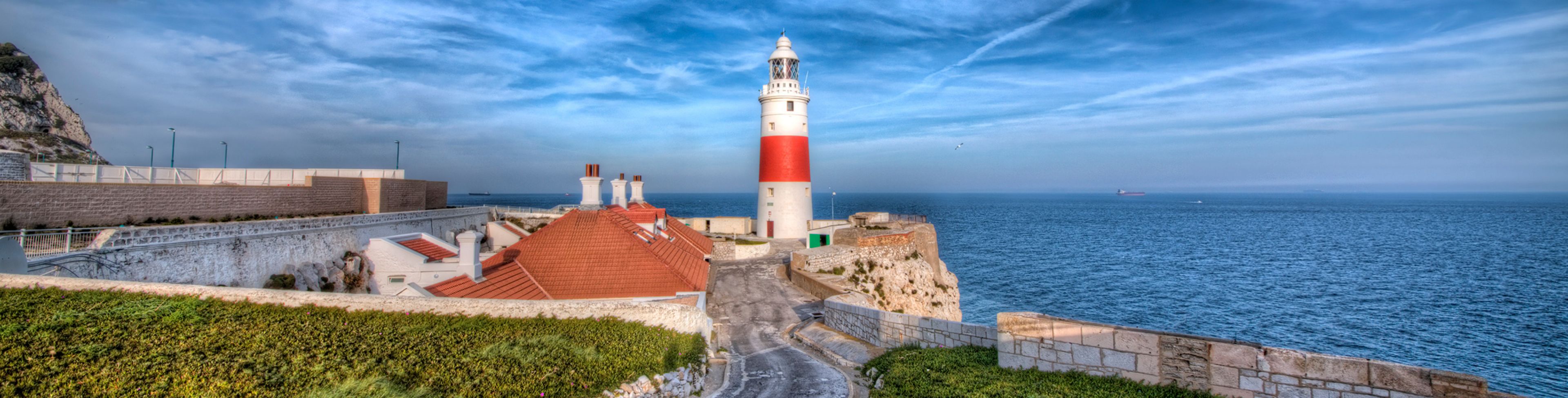 Lighthouse overlooking deep blue sea waters.
