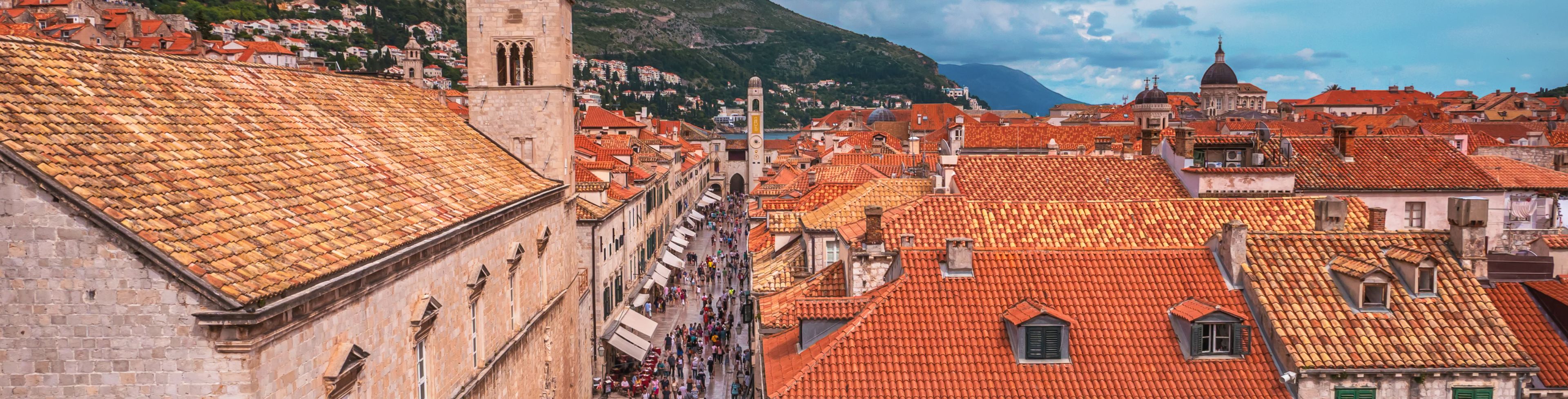 View of city buildings and people filling the streets.