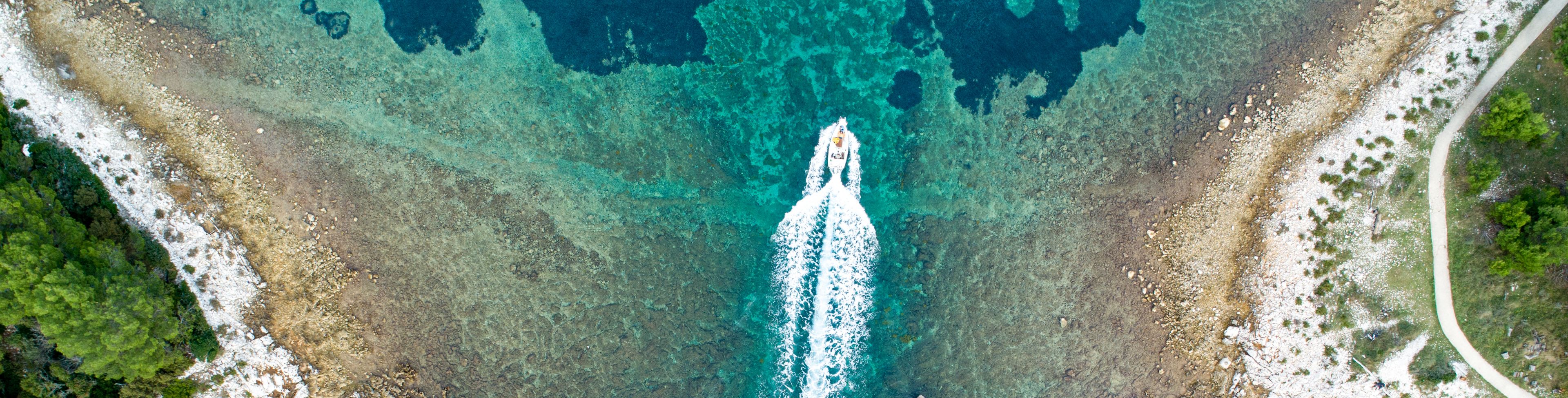 Sky view of a boat boating on the ocean.