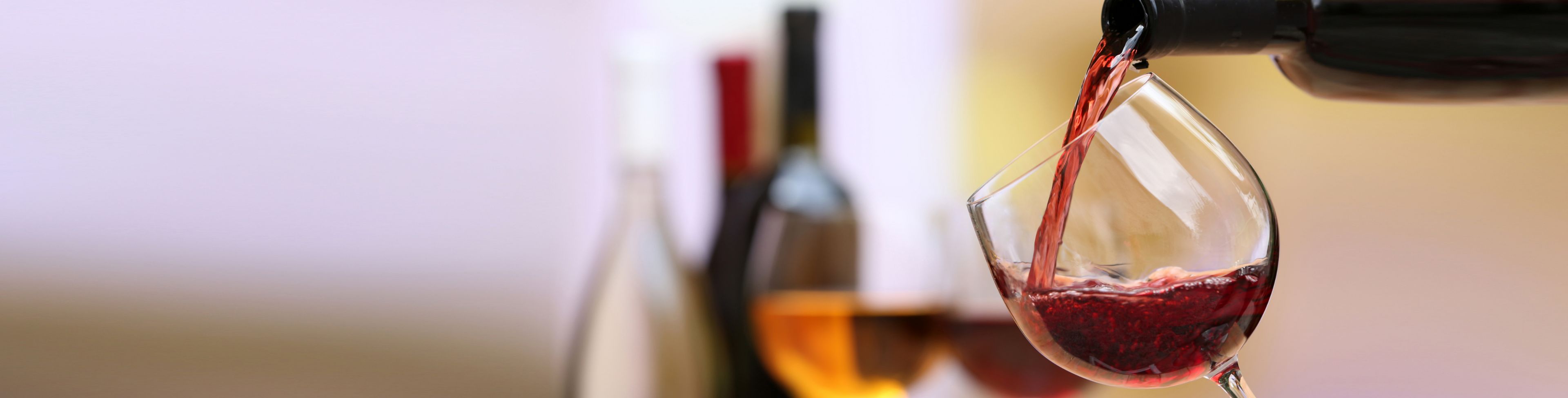 Wine being poured into a wine glass.