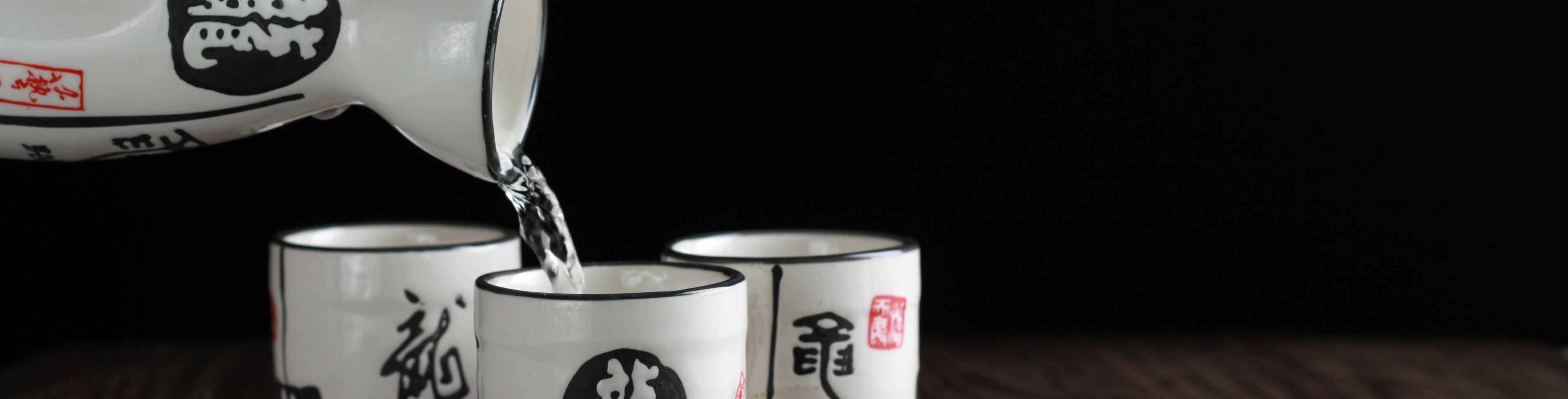 Tea being poured into smaller cups.
