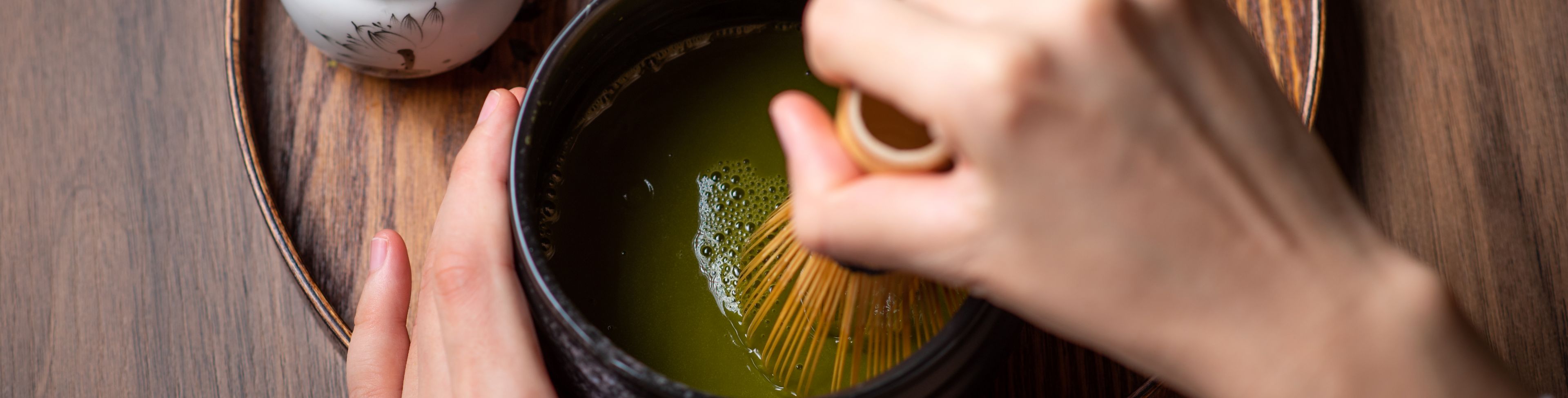 Matcha being mixed in a bowl.