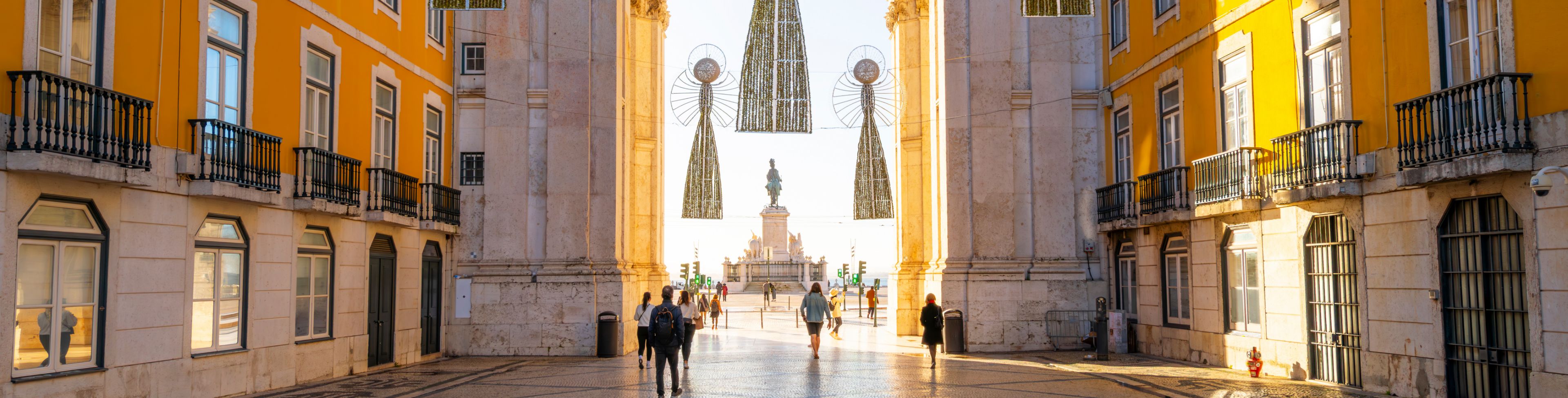 A courtyard opens up to a decorated arch.