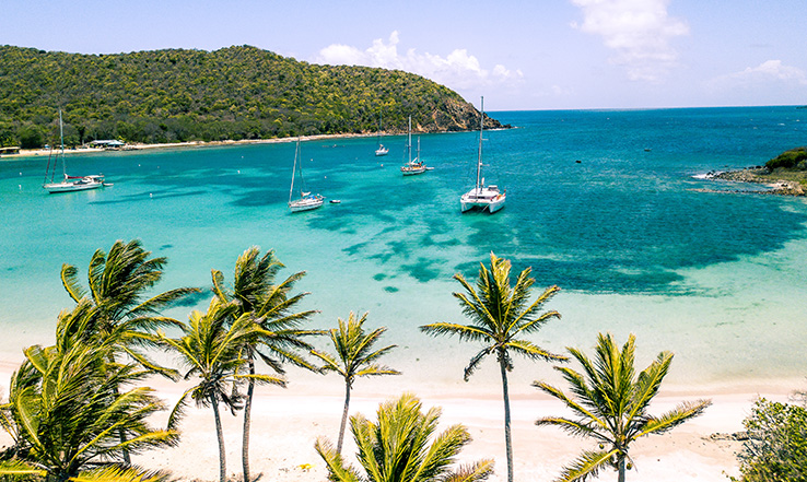 Aerial view of part of the island and a white sandy beach. 