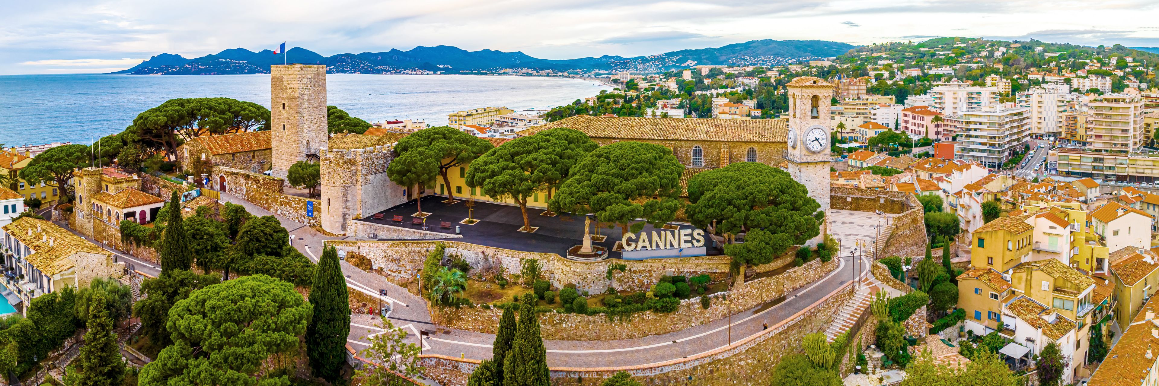 Aerial view of Cannes city with "Cannes" sitting the middle of the city.