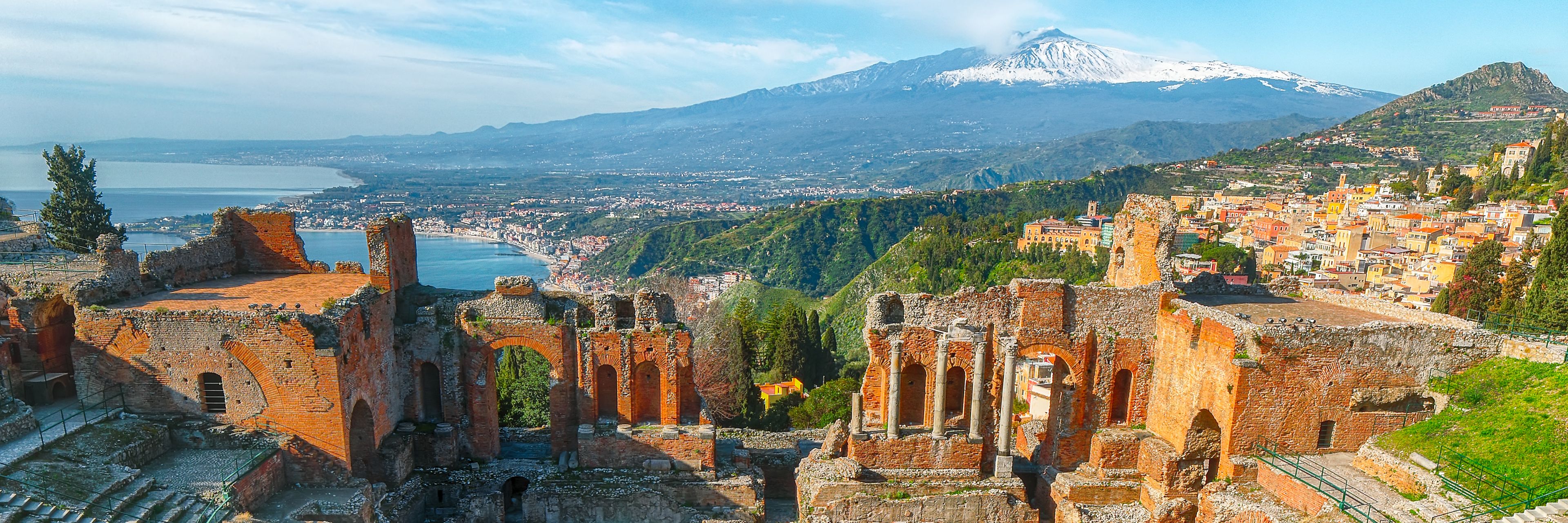 Ruins on a mountaintop overlooking the city and ocean.