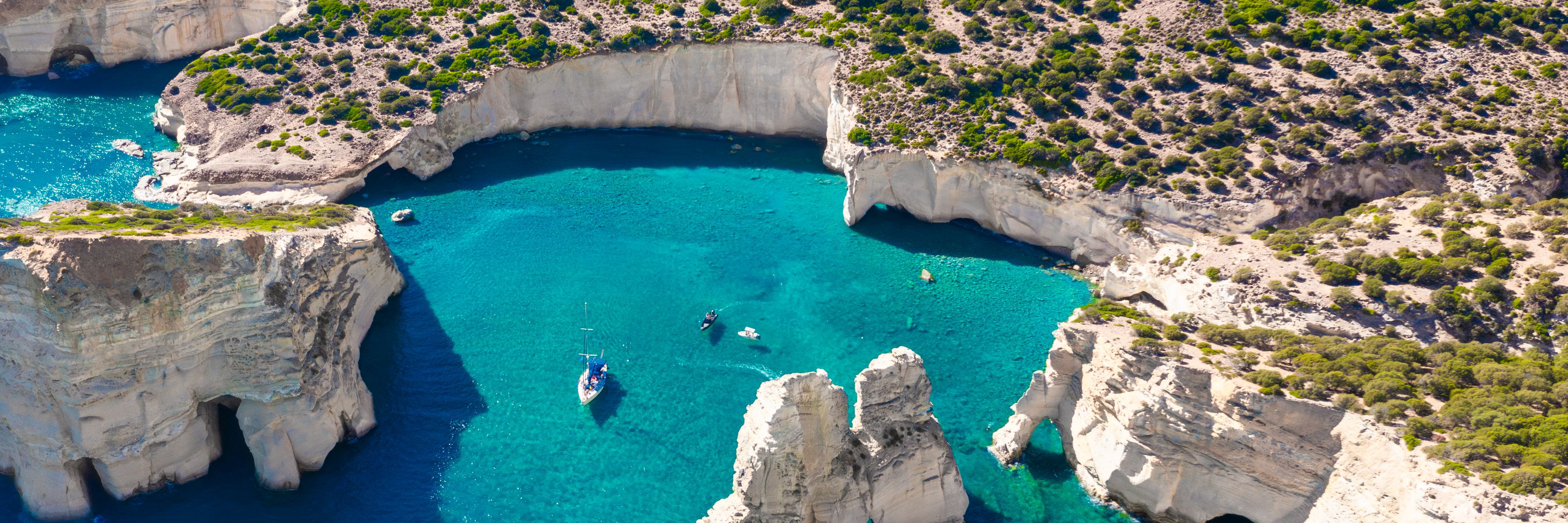 Aerial view of cove full of water, surrounded by cliffs.