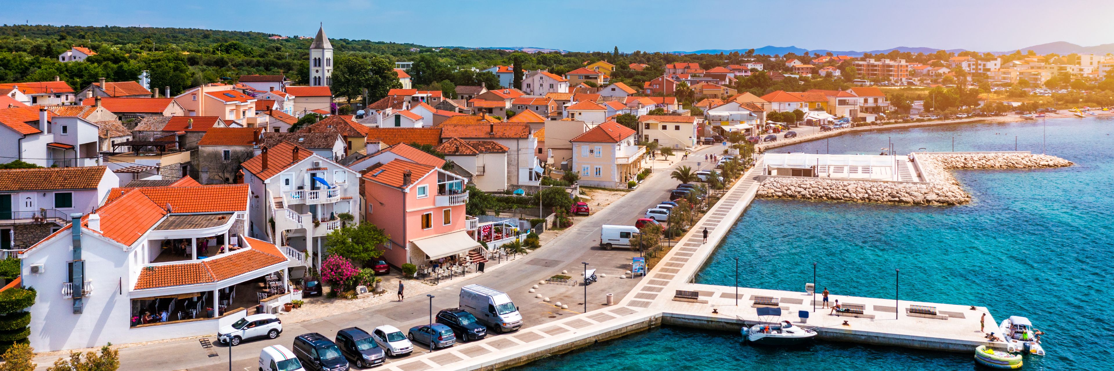 Road separates city from ocean and docks.