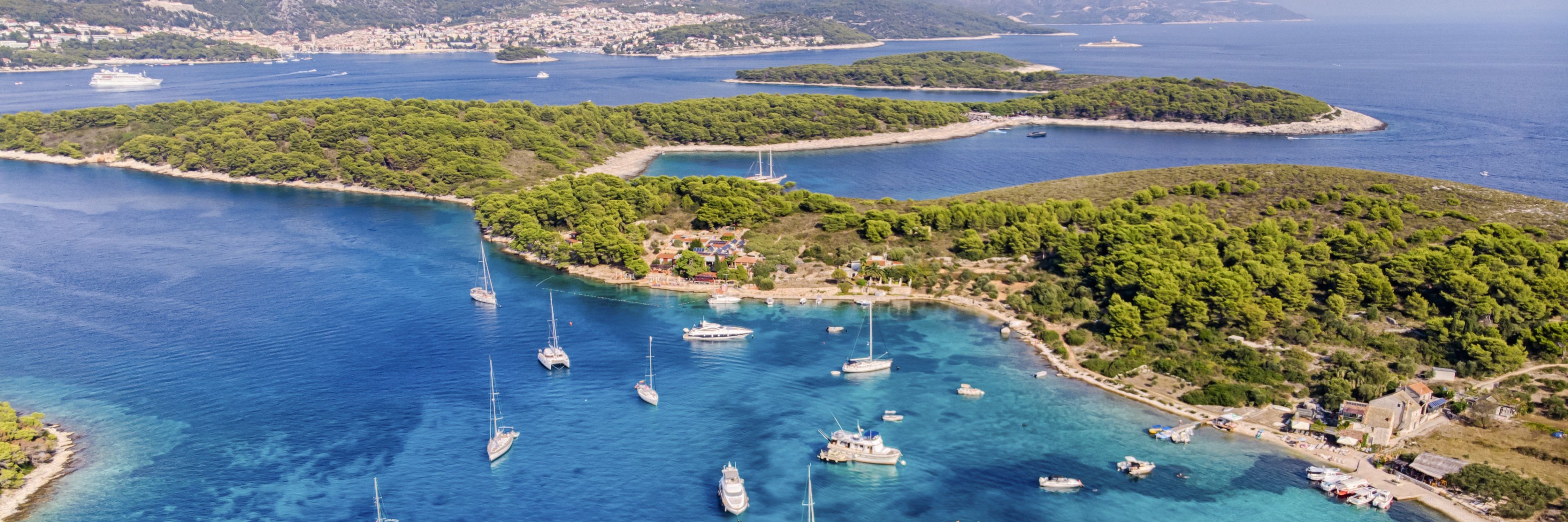 Sky view of Island and ocean, with a variety of boats anchored.