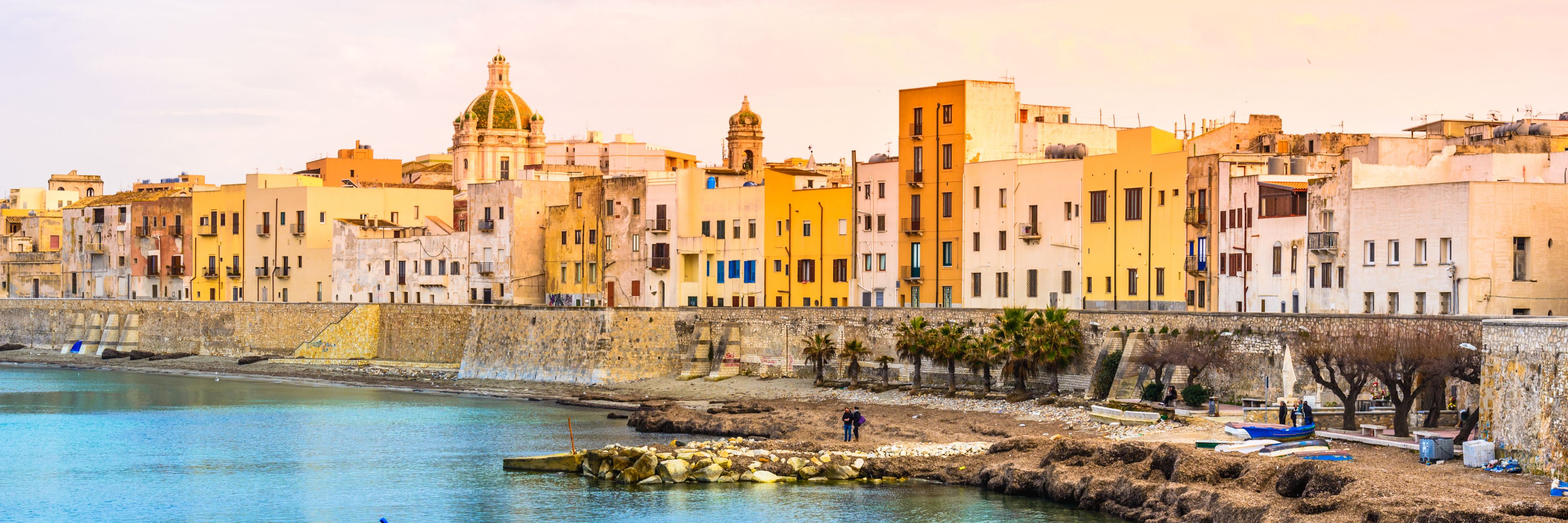 City buildings overlooking the ocean.