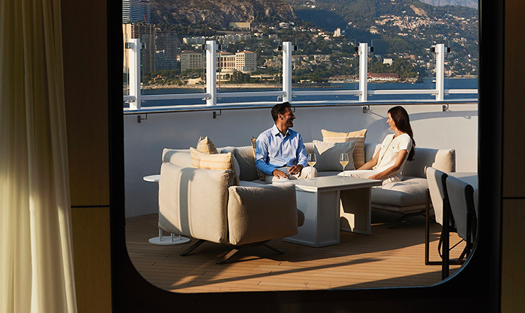 Man and woman sitting on a private deck. 