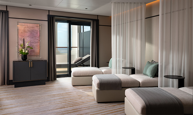 Three lounging couches along a wall with curtains separating them.