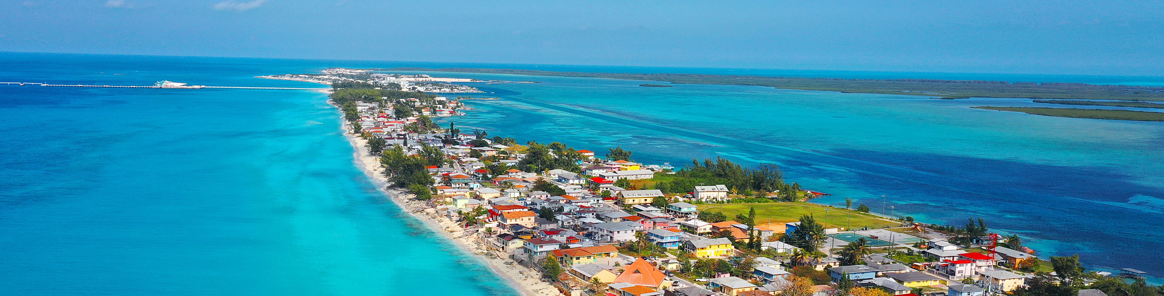 Aerial view of city surrounded by ocean water.