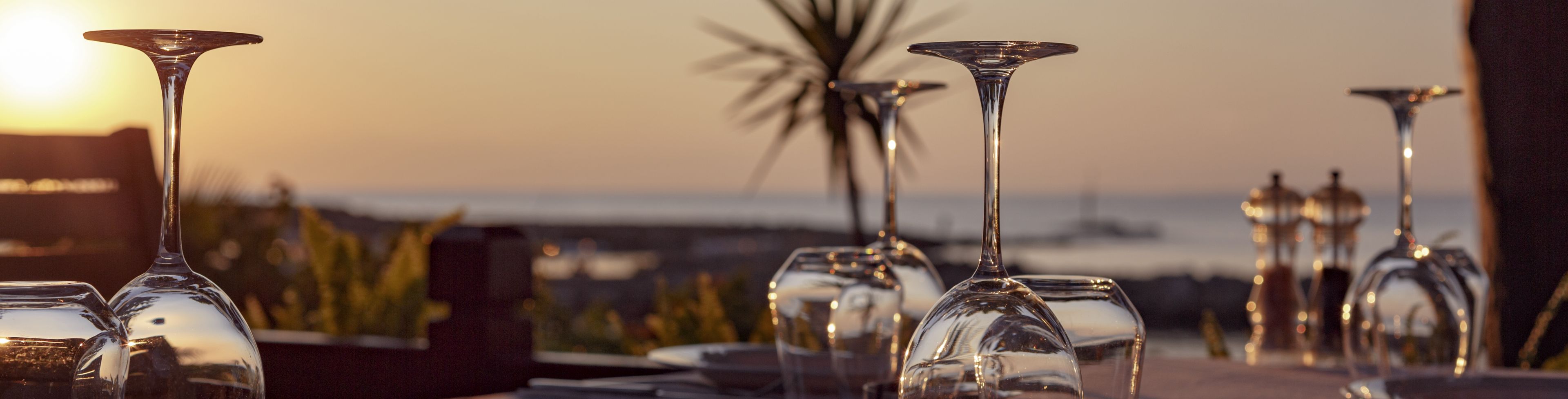 The sun shines down on a table set for a meal. 