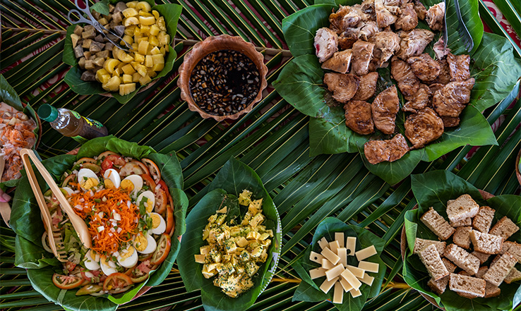 Variety of food inside leaf bowls.