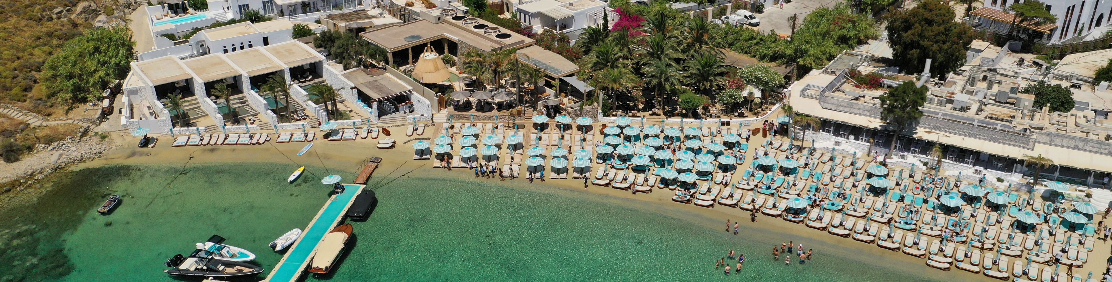 Sky view of beach full of chairs and cabanas.