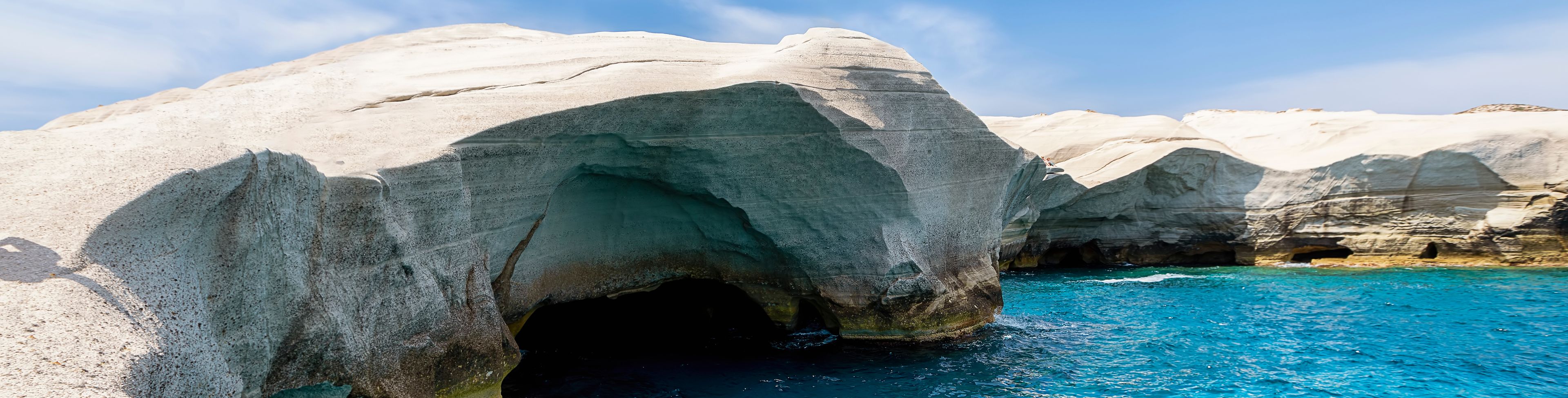 Cliffs over crystal blue water.