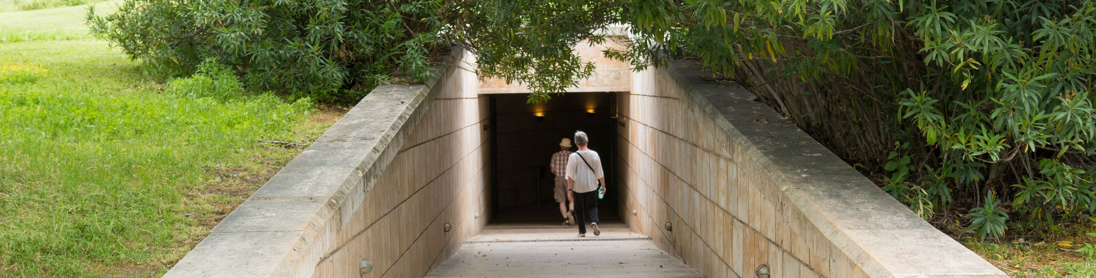 People entering tomb tunnel.