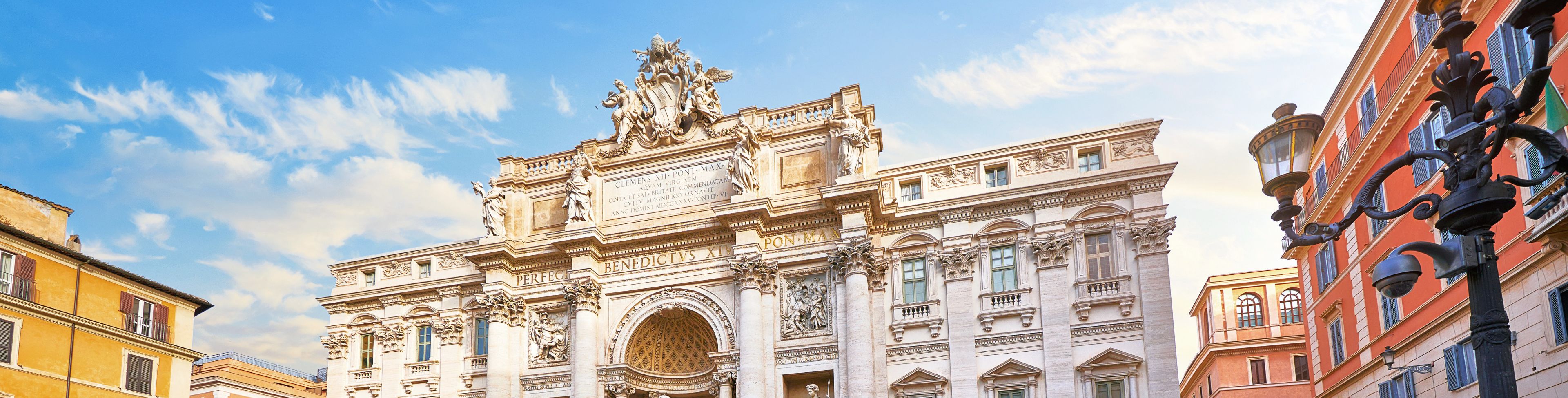 Trevi fountain surrounded by old buildings.