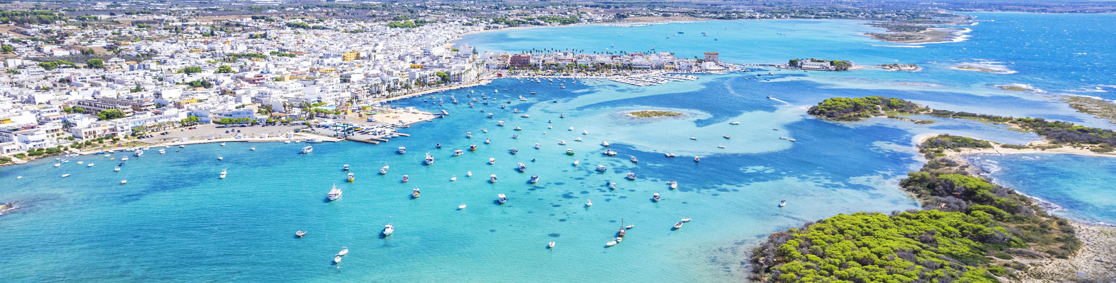 Many boats on crystal blue water.