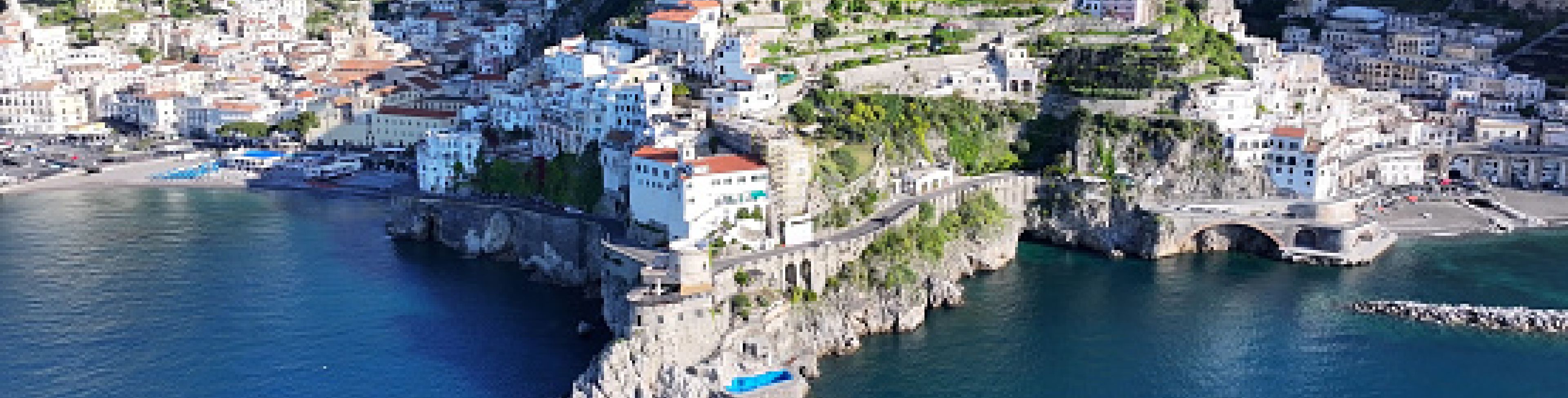 City on a mountain side on the edge of the water.