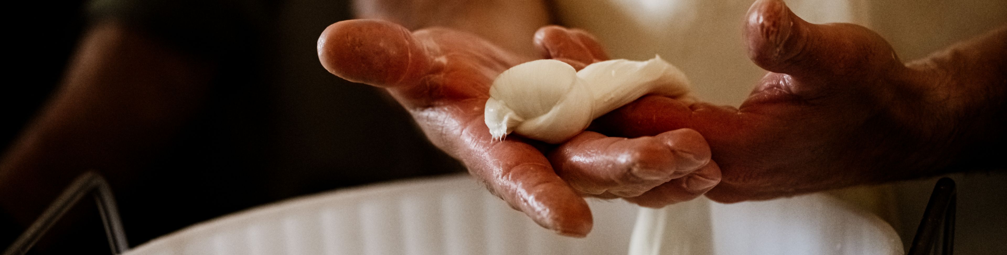 Someone making dough with their hands. 