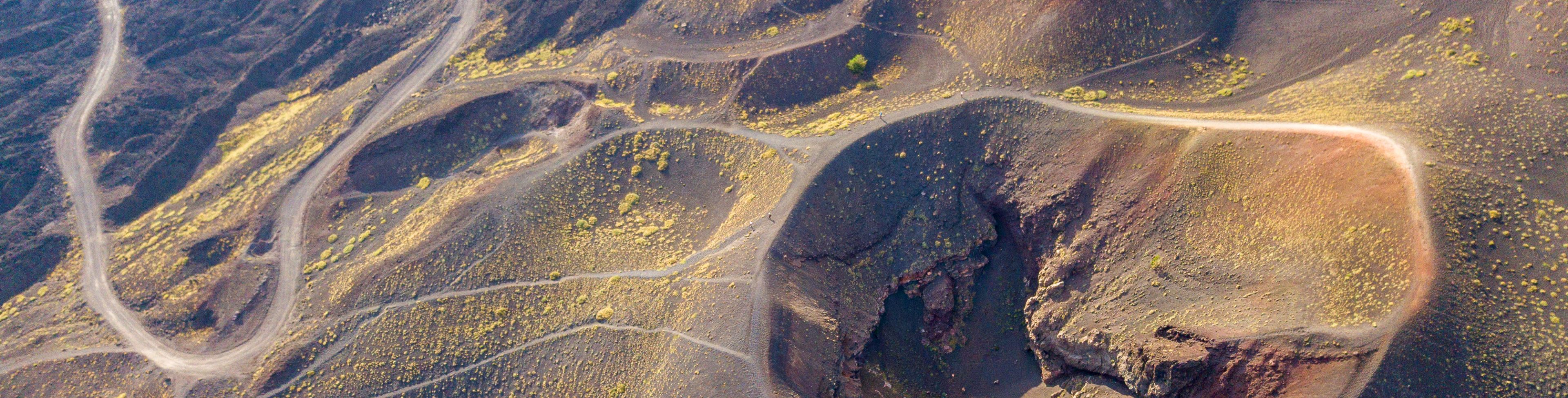 Aerial view of Mt Etna surrounded by winding paths and roads.