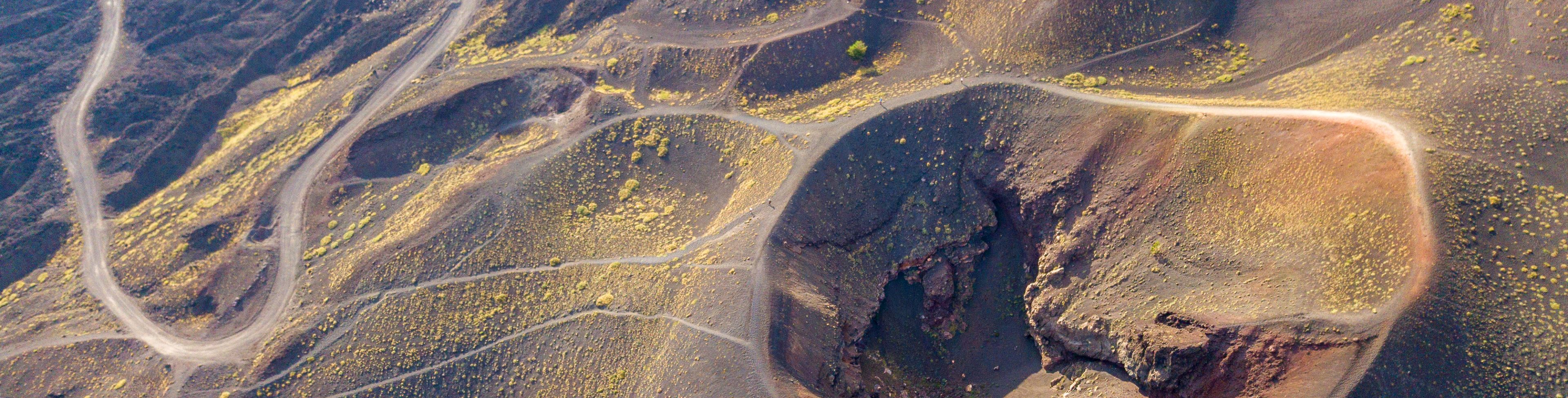Aerial view of Mt Etna surrounded by winding paths and roads.