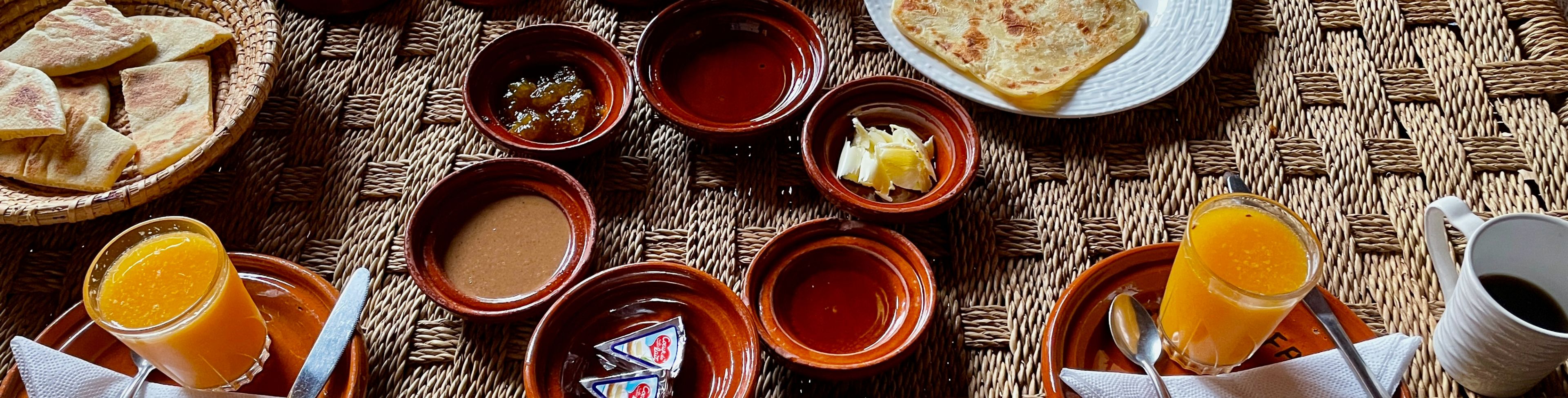 Different local breakfast foods arranged on a table for consumption.