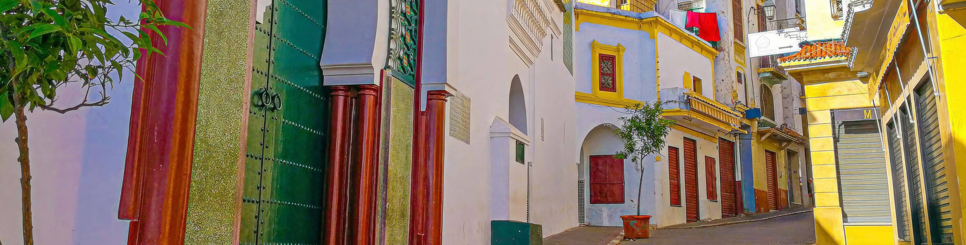 Colorful buildings line a walkway in Tangier, Morocco.